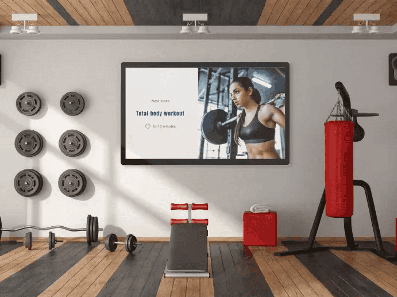 Digital signage displaying a 'Total Body Workout' class schedule.